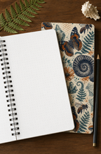 The Natural World Archive notebook open to blank dotted pages with the printed cover visible