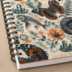 Close-up of The Natural World Archive notebook cover print, black Wire-O binding, and page edges
