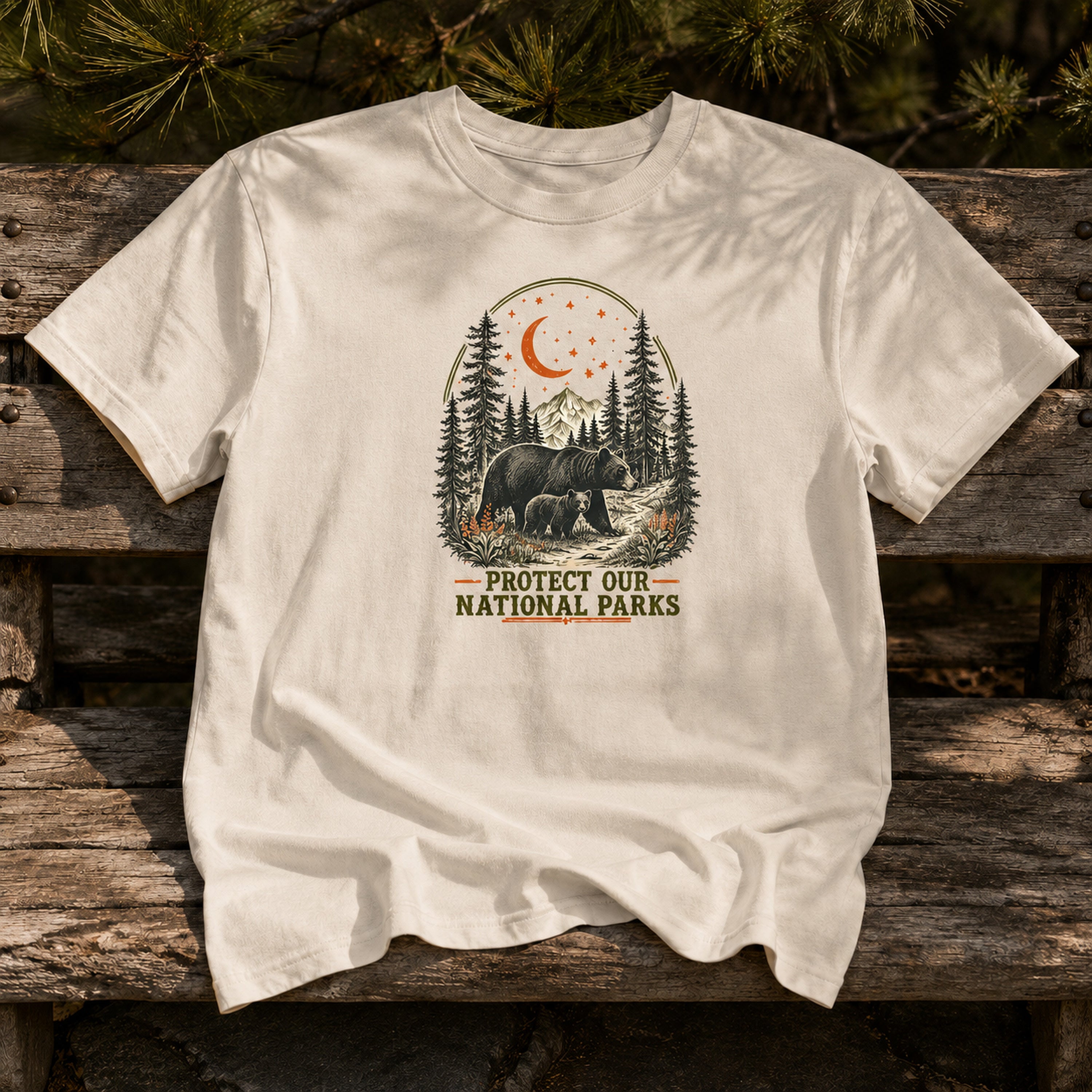 Moonlit Bear national parks tee in Ivory on an outdoor bench