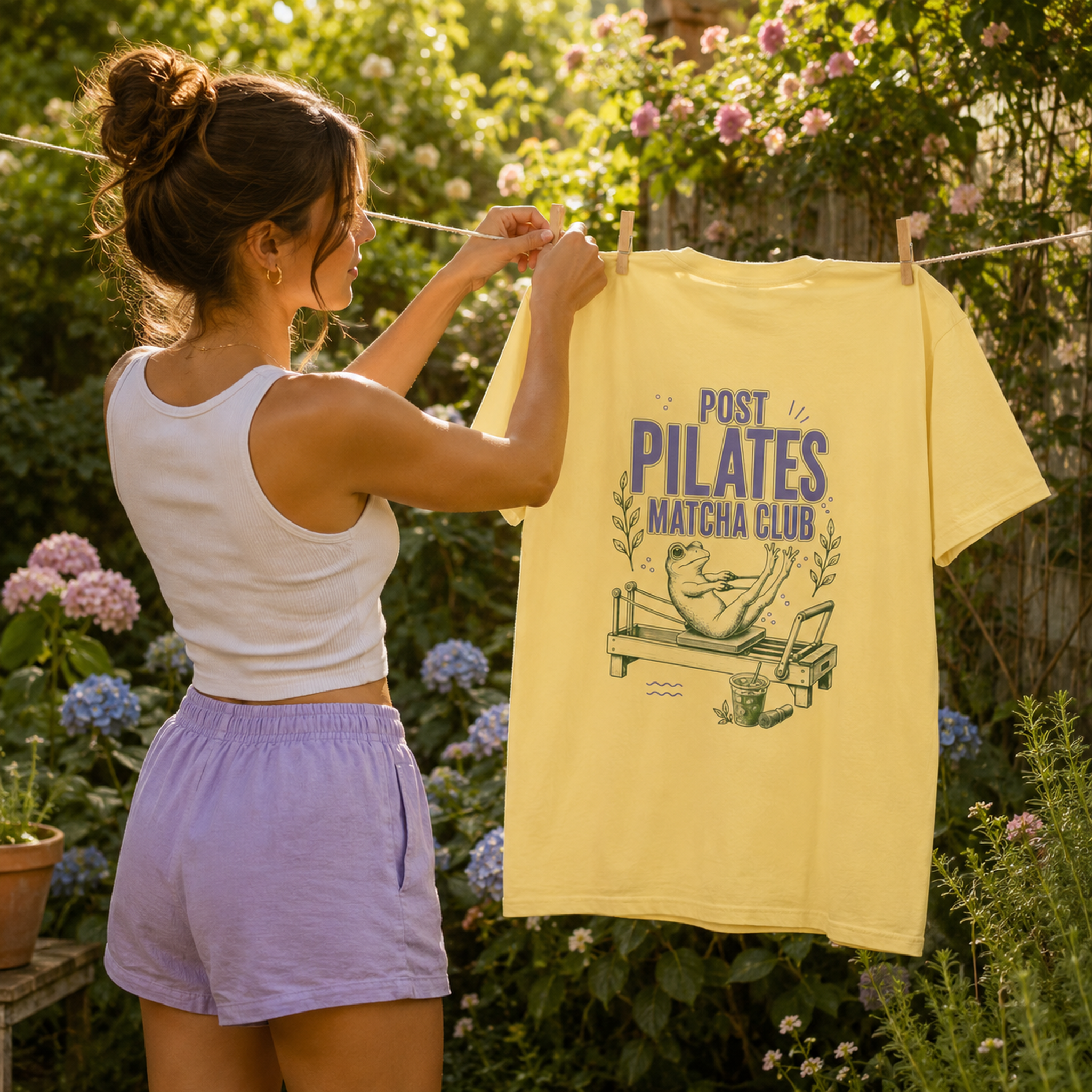 Banana Comfort Colors Post Pilates Matcha Club tee on a sunny backyard garden clothesline