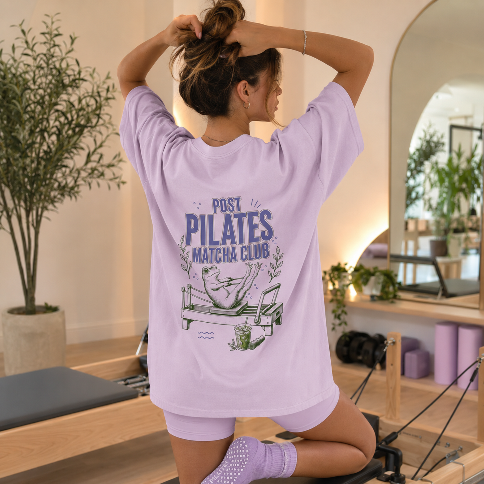 Orchid lavender Post Pilates Matcha Club tee worn in a Pilates studio