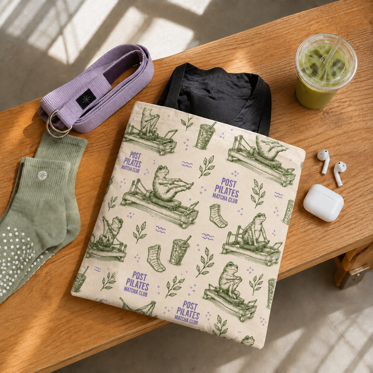 Post Pilates Matcha Club tote flat lay with grip socks, iced matcha, and studio essentials