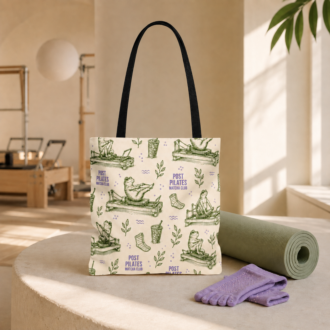 Post Pilates Matcha Club tote with black handles attached inside, styled with a sage mat and lavender grip socks