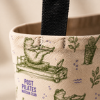 Close-up of Post Pilates Matcha Club tote fabric print seam and black strap