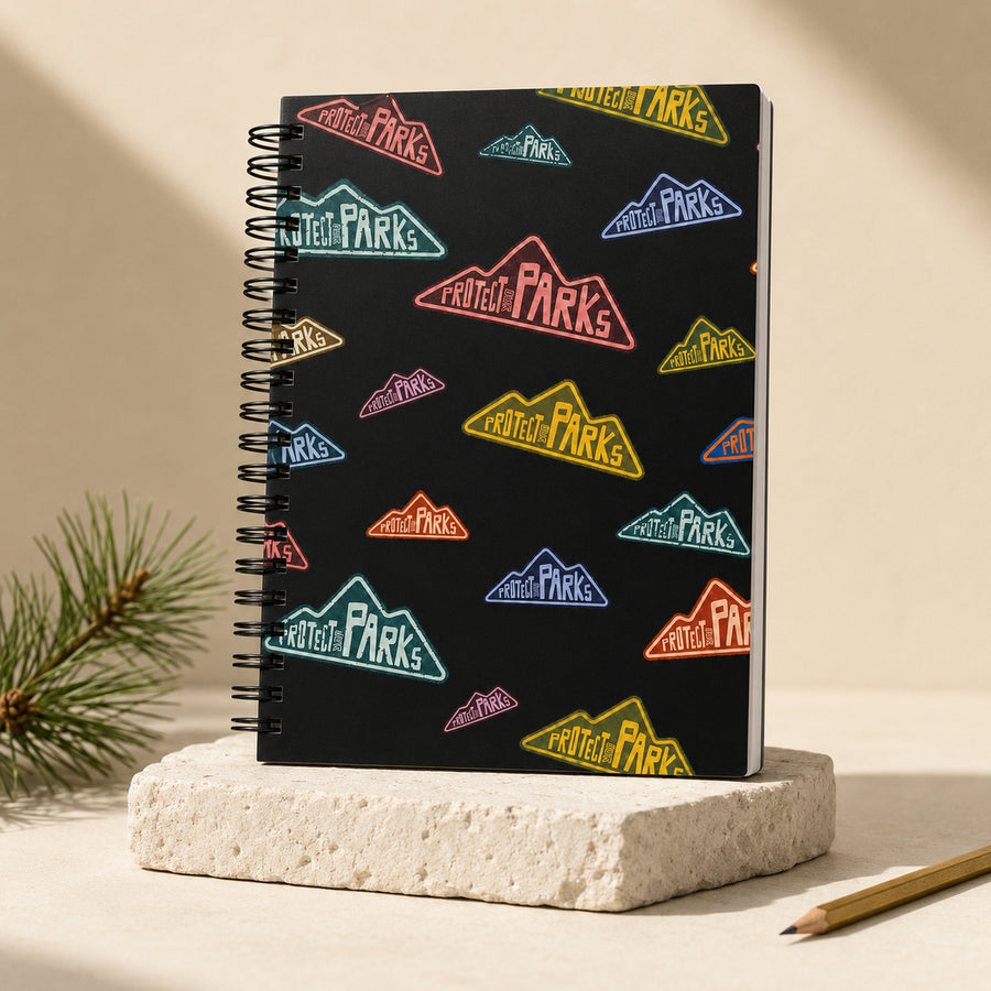 Protect Our Parks black spiral notebook — upright studio hero