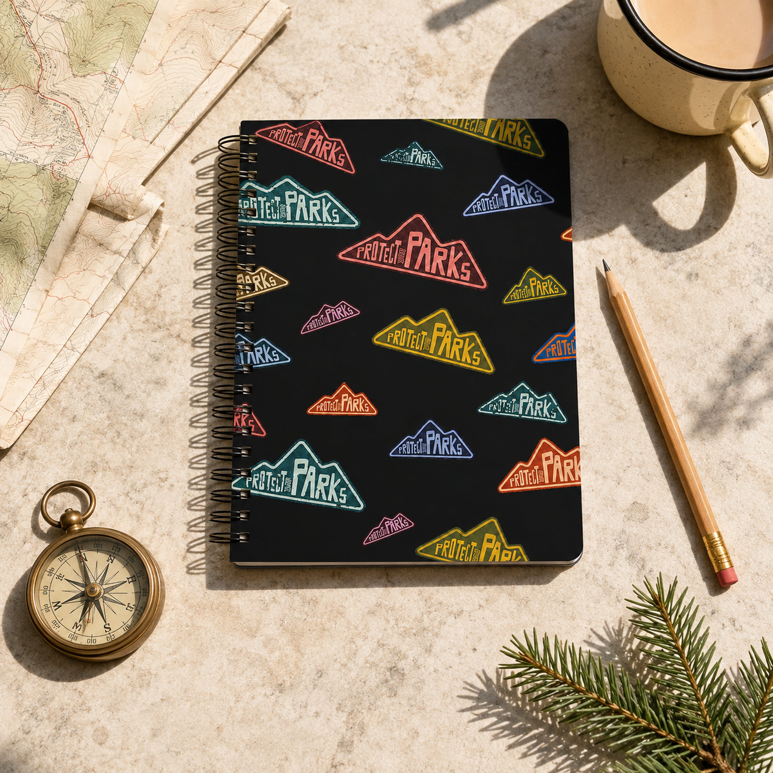 Protect Our Parks black spiral notebook — topographic map flat lay