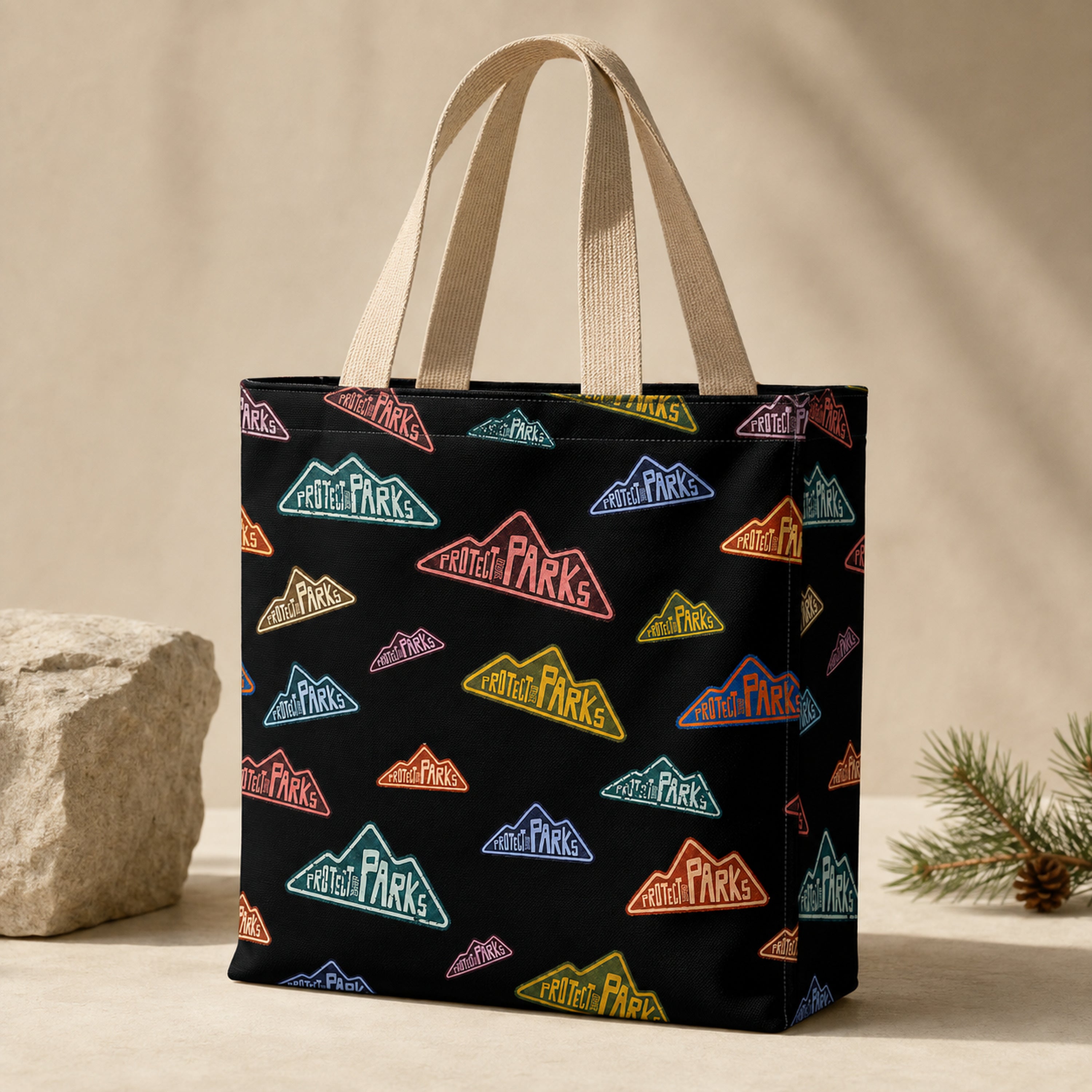 Protect Our Parks black all-over-print tote — beige handle hero