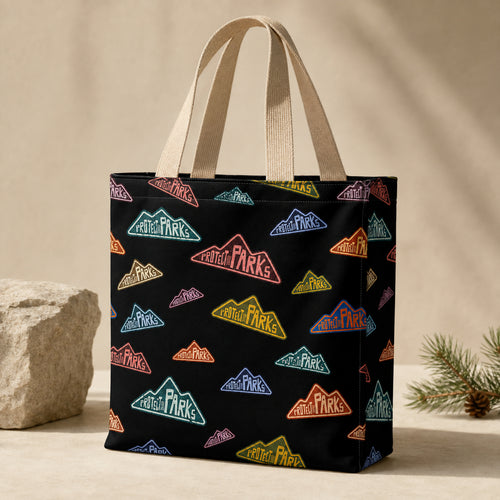 Protect Our Parks black all-over-print tote — beige handle hero