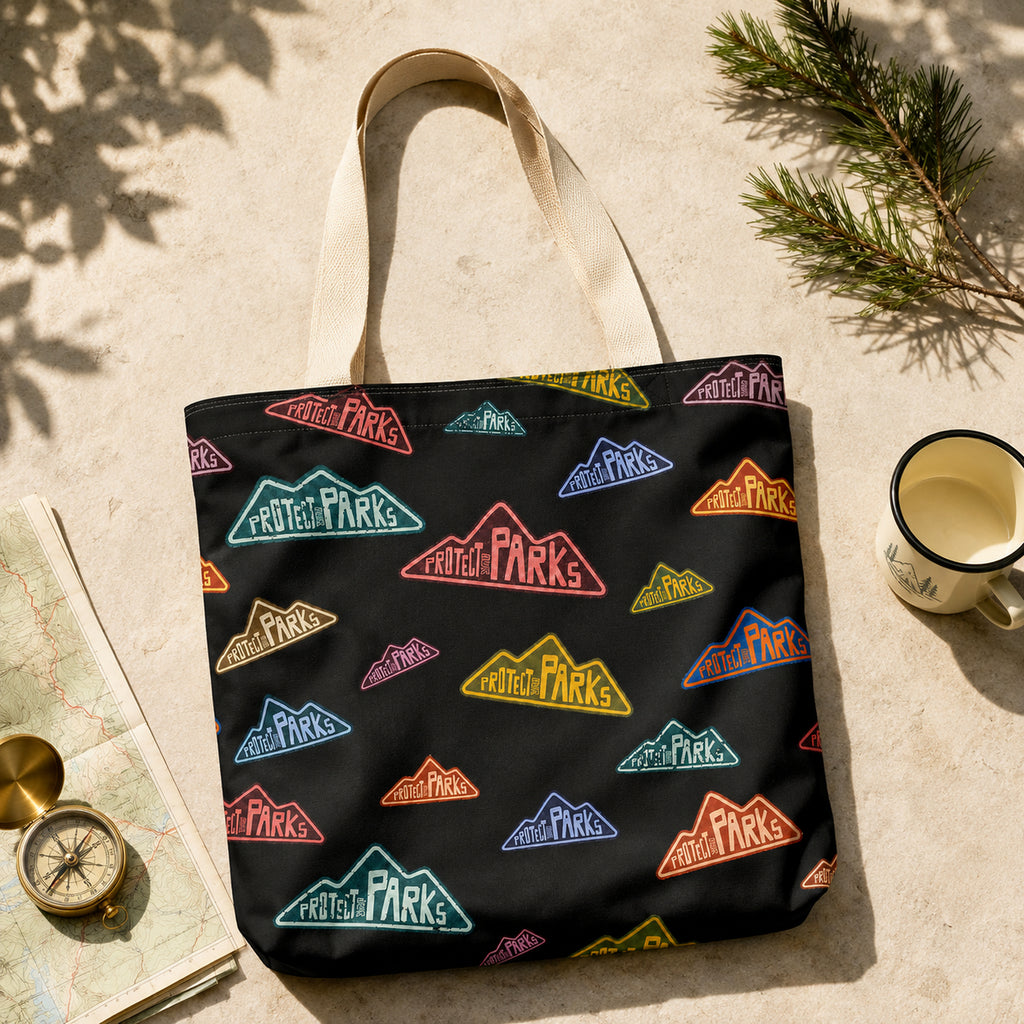 Protect Our Parks black all-over-print tote — topographic map flat lay