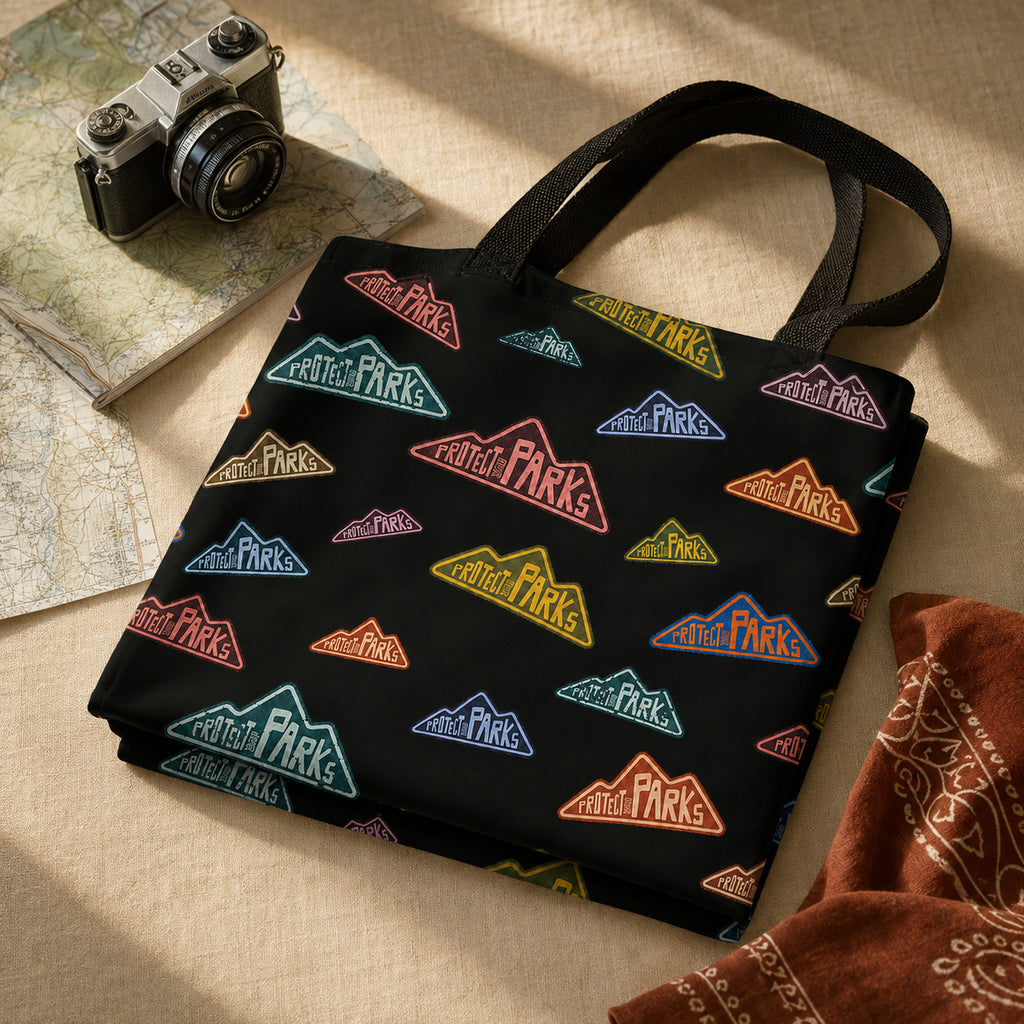 Protect Our Parks black all-over-print tote — folded tote product scene