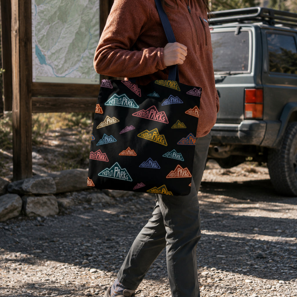 Protect Our Parks black all-over-print tote — trailhead lifestyle carry