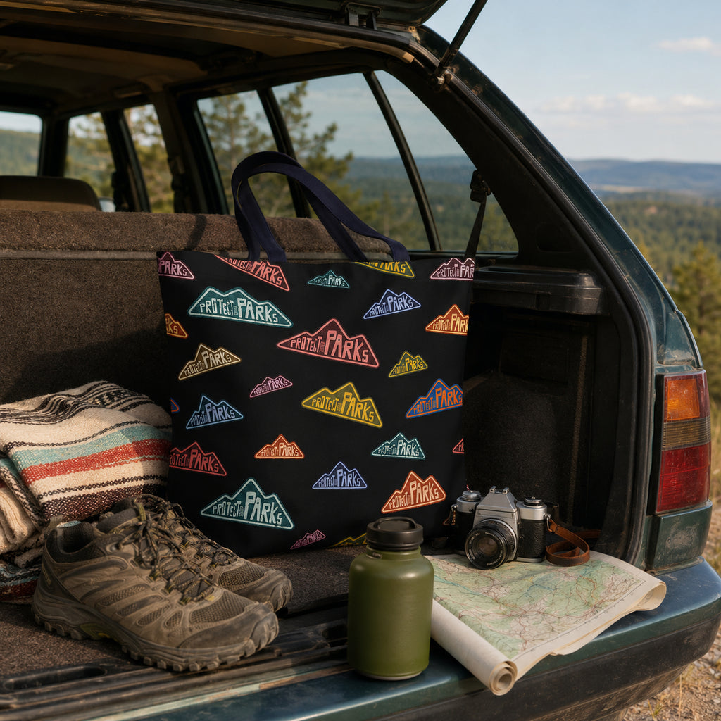 Protect Our Parks black all-over-print tote — road trip car trunk