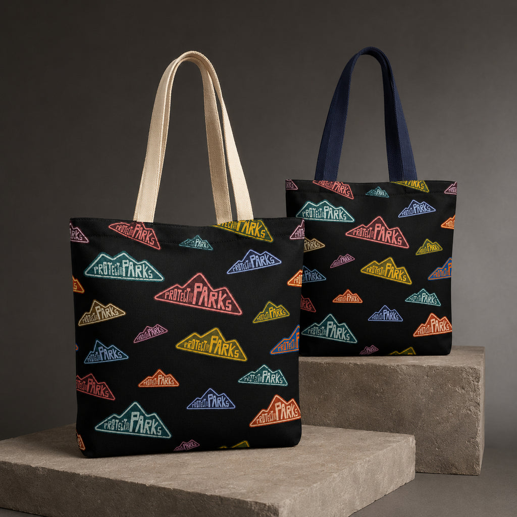 Protect Our Parks black all-over-print tote — two handle variants final hero