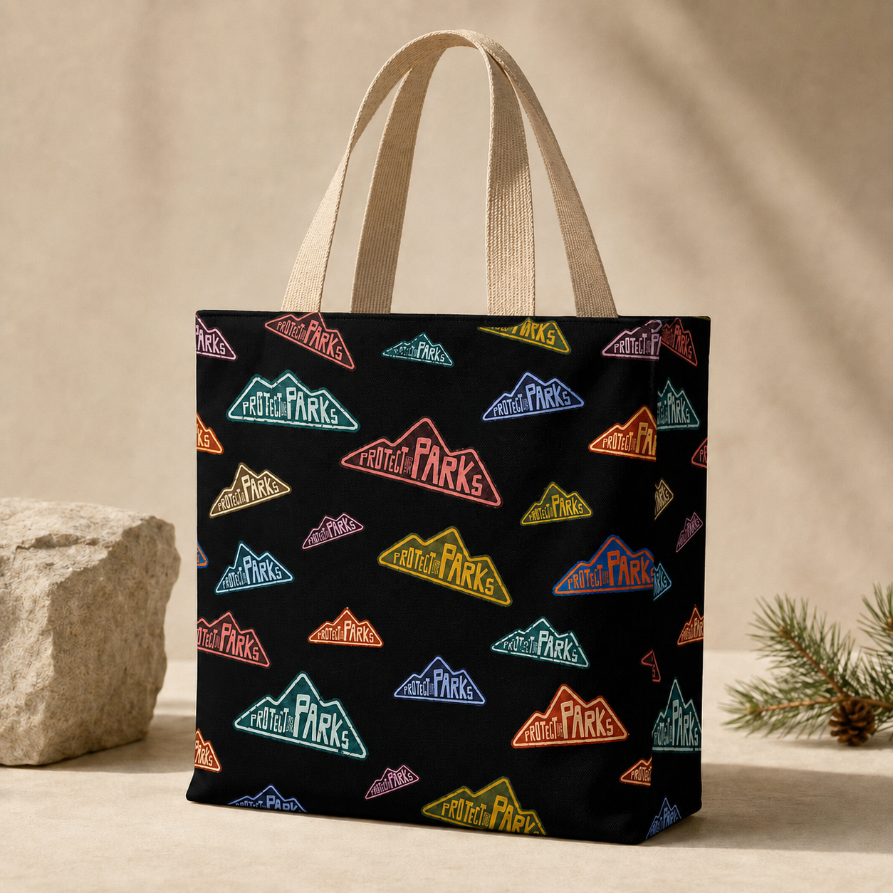 Protect Our Parks all-over tote with natural handles attached inside on a neutral studio set